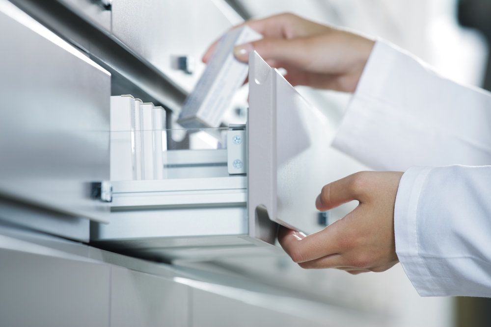 a doctor files a medicine container
