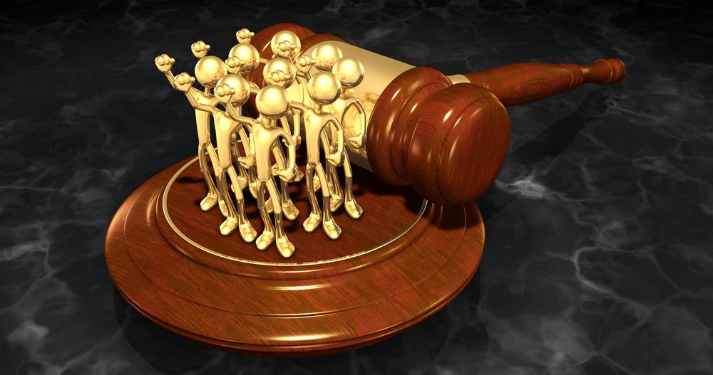 Illustration of a group of golden figurines standing together on a block.
